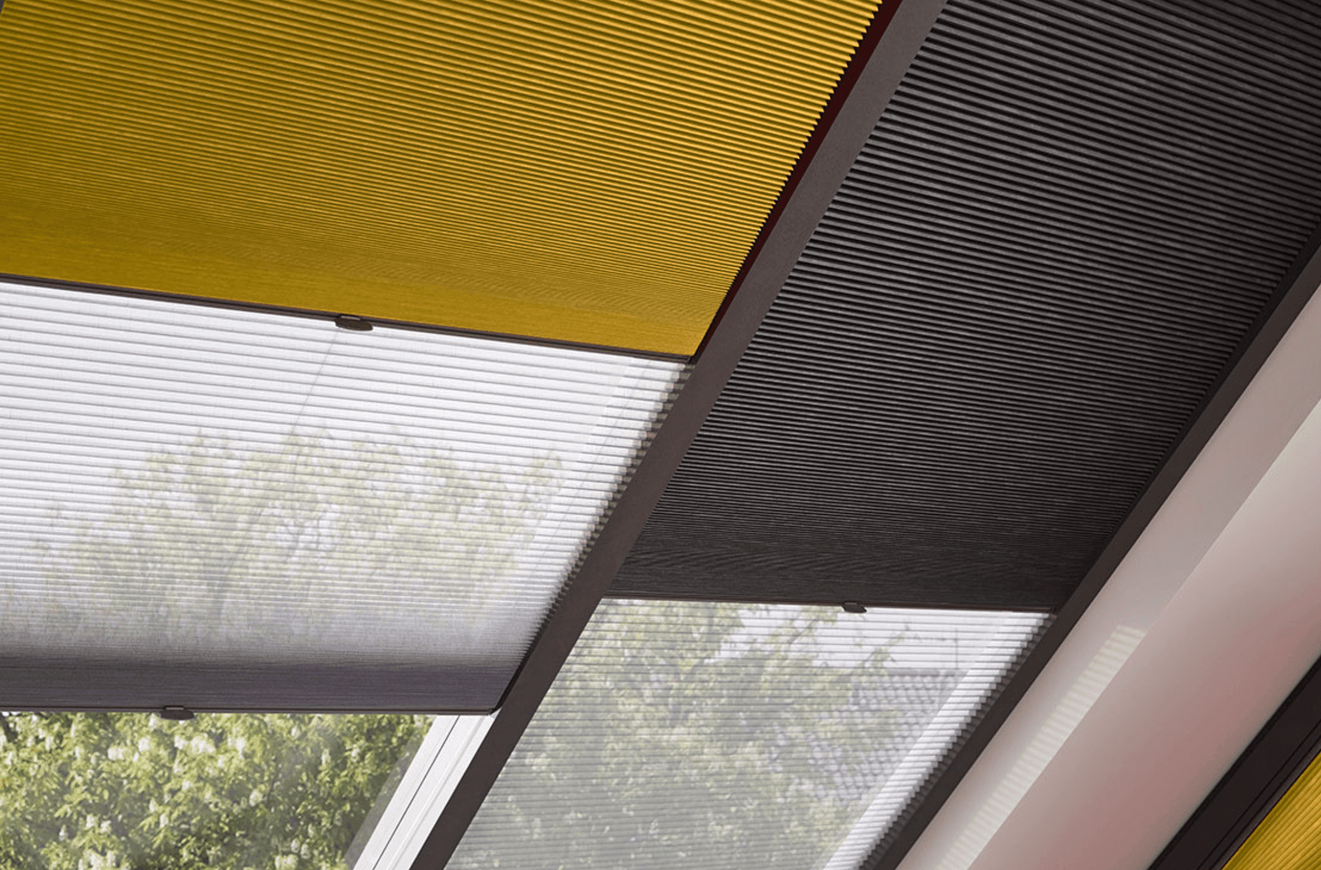 Modern ceiling with yellow, black, and white blinds filtering sunlight.